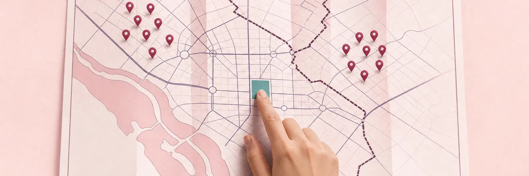Hand tracing a highlighted DC city block on a district map beside grouped anonymous registry markers.